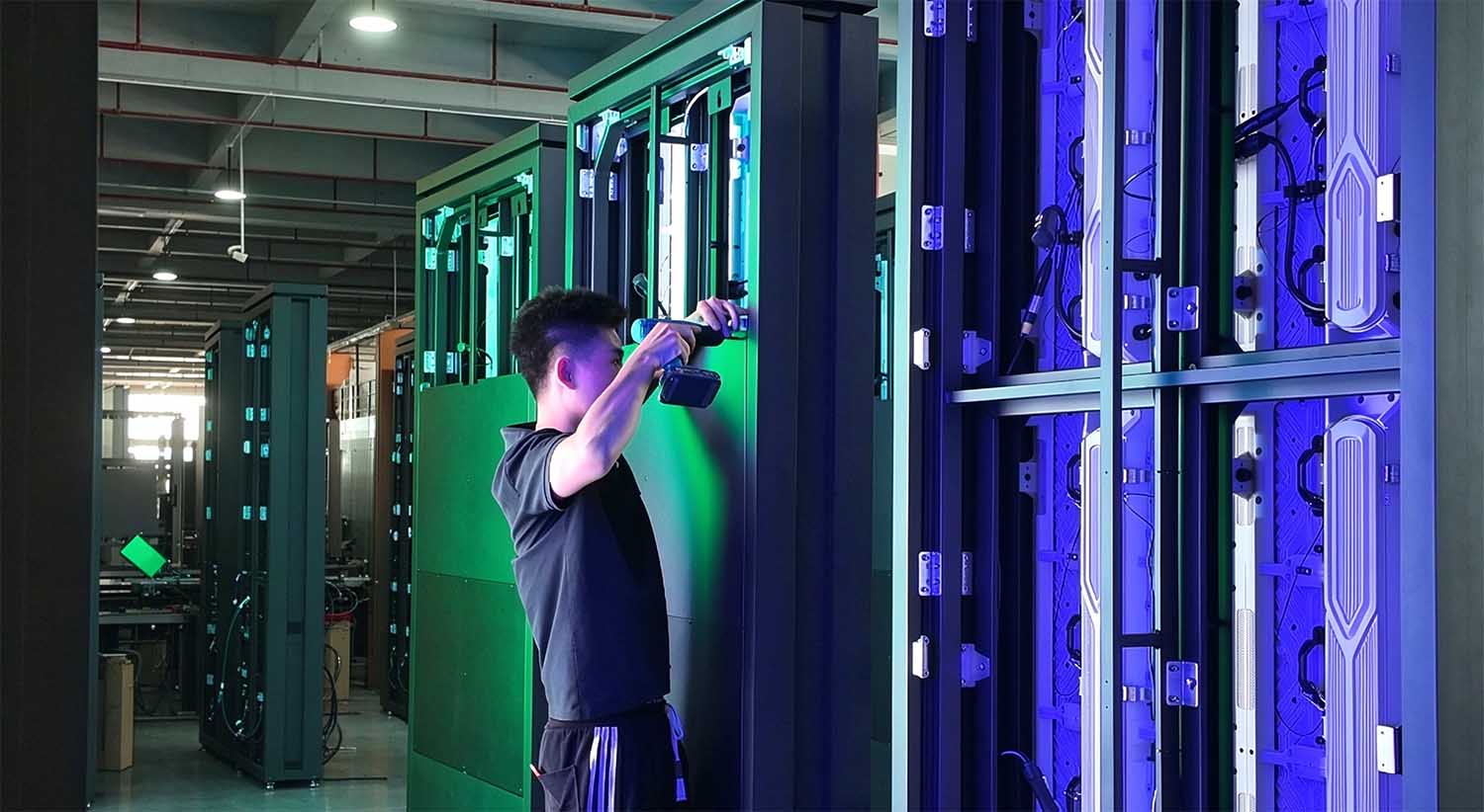 Outdoor LED Totem Display Assembly Technicians assembling an outdoor LED totem display during the manufacturing process